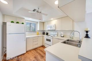 1645 Spoonbill Lane, Unit C Naples, FL 34105 - Photo 9 of 50 Kitchen with light countertops, white appliances, light wood finished floors, a peninsula, and recessed lighting