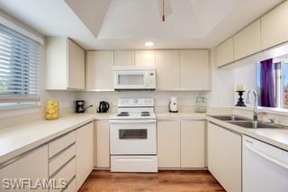 1645 Spoonbill Lane, Unit C Naples, FL 34105 - Photo 10 of 50 Kitchen with white appliances, light countertops, light wood-style flooring, and cream cabinets