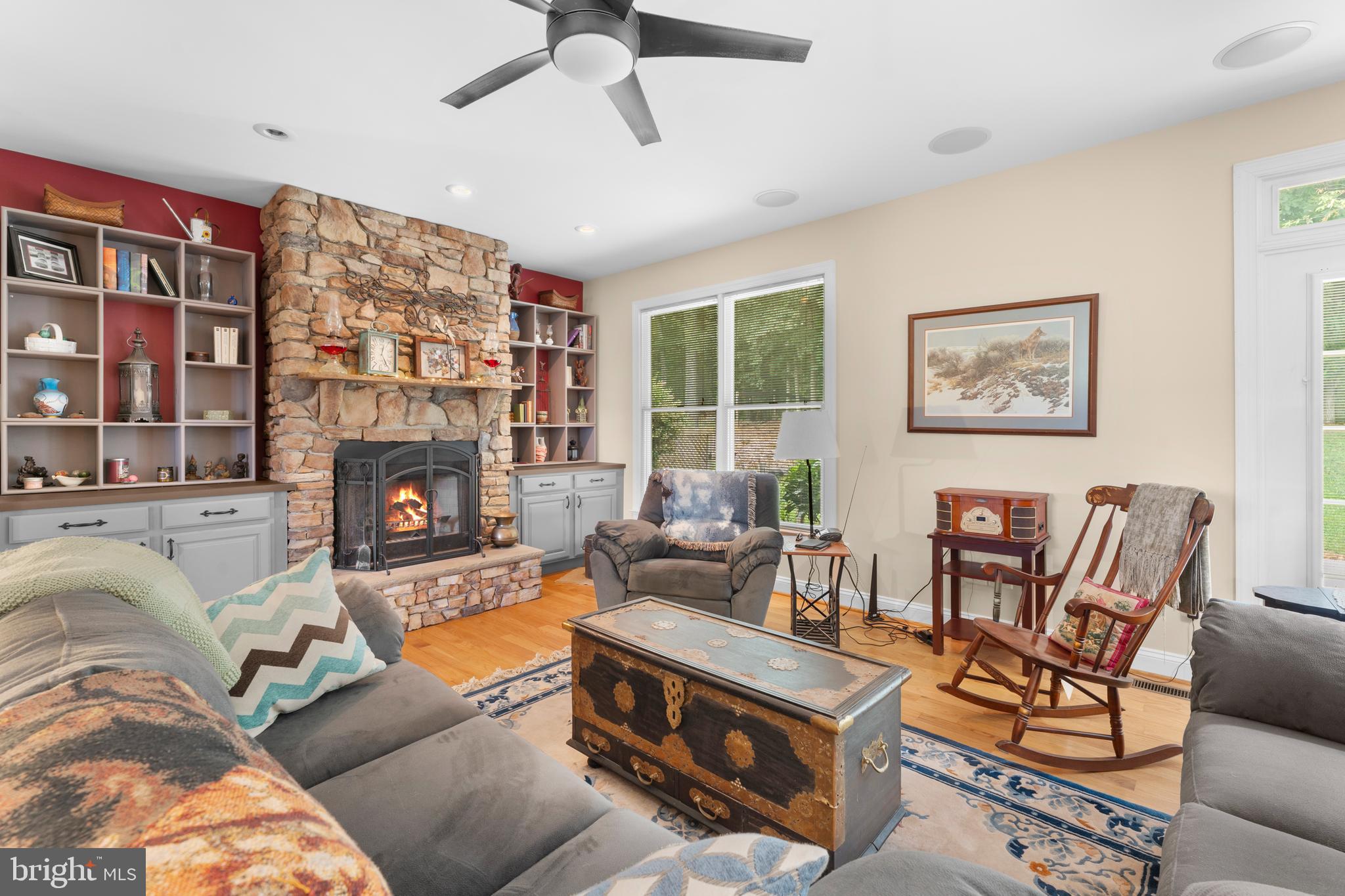 8260 River Hills Lane Rixeyville, VA 22737 - Photo 16 of 104 a living room with furniture a fireplace and a large window