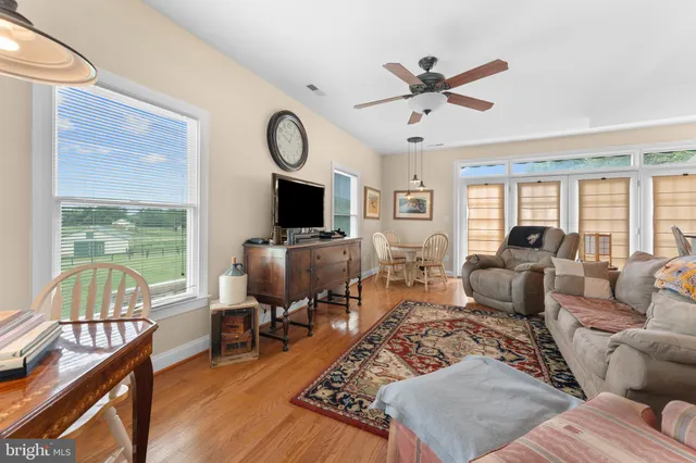a view of an empty room with furniture and a window