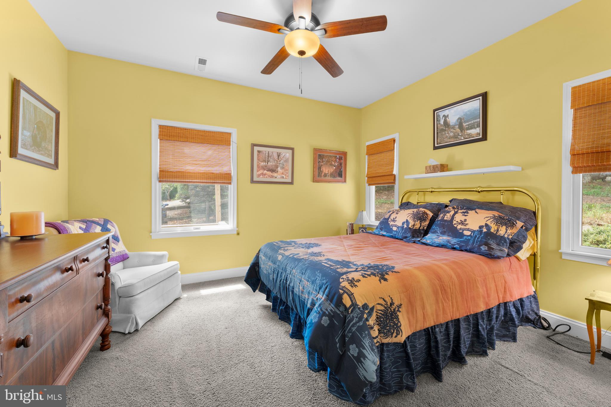 8260 River Hills Lane Rixeyville, VA 22737 - Photo 54 of 104 a bedroom with a bed and a chandelier
