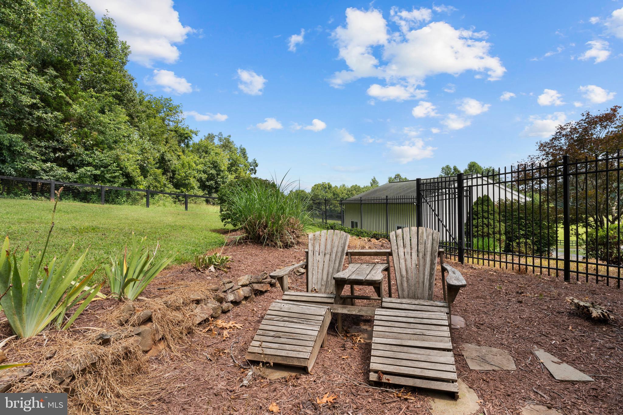 8260 River Hills Lane Rixeyville, VA 22737 - Photo 94 of 104 a view of a patio with a table chairs and a backyard
