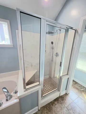 a bathroom with a shower and a sink