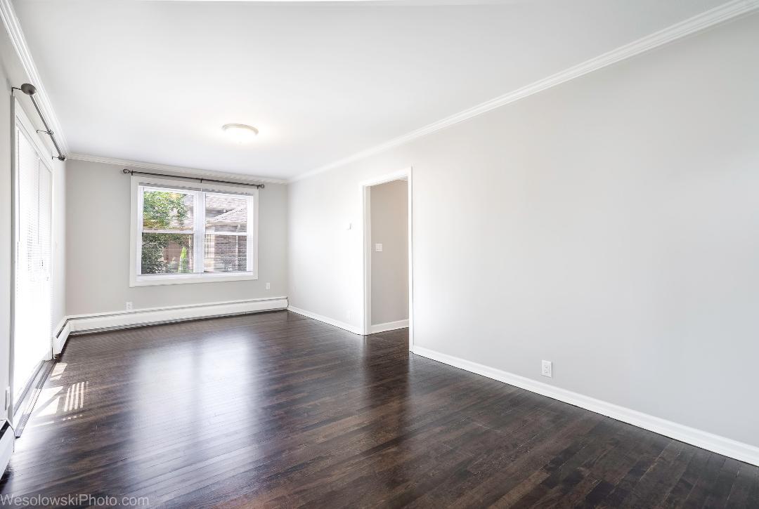7700 Garden Lane Justice, IL 60458 - Photo 4 of 17 an empty room with wooden floor and windows