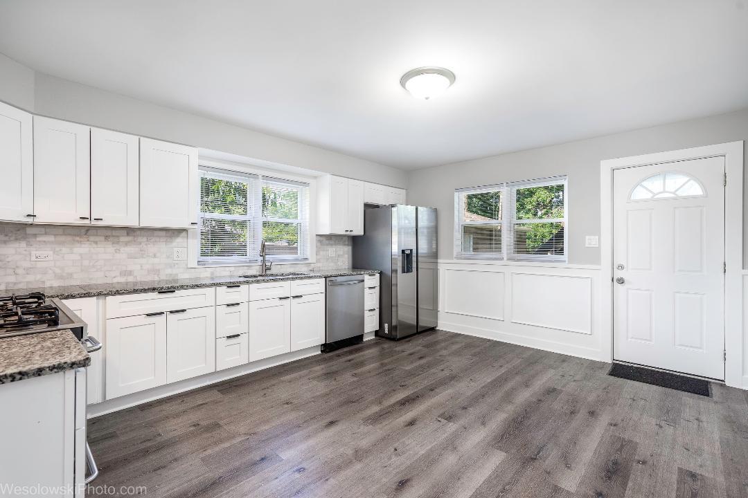 7700 Garden Lane Justice, IL 60458 - Photo 6 of 17 a kitchen with granite countertop a stove a sink and a refrigerator