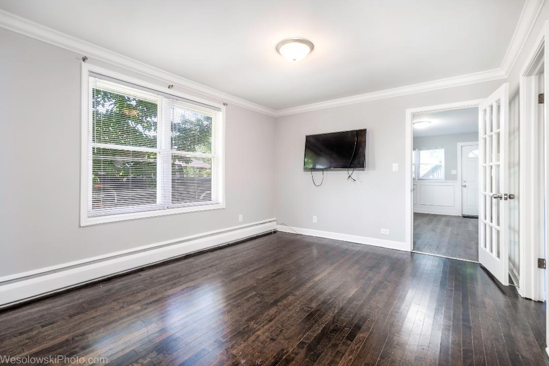 7700 Garden Lane Justice, IL 60458 - Photo 9 of 17 a view of an empty room with wooden floor and a window
