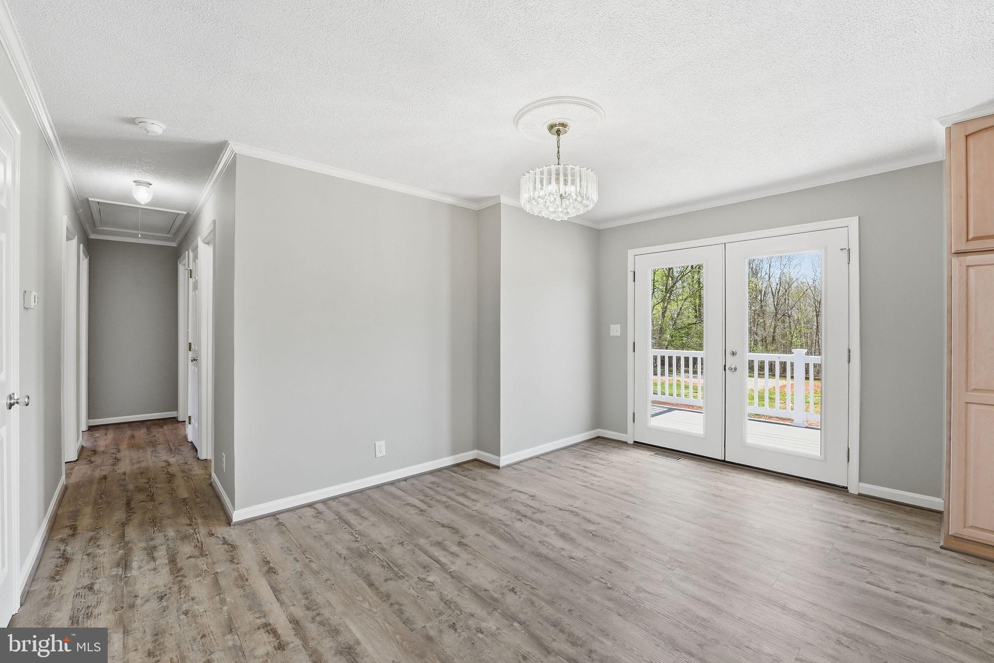 22064 Yellow Bottom Road Lignum, VA 22726 - Photo 13 of 50 a view of an empty room with wooden floor and a window