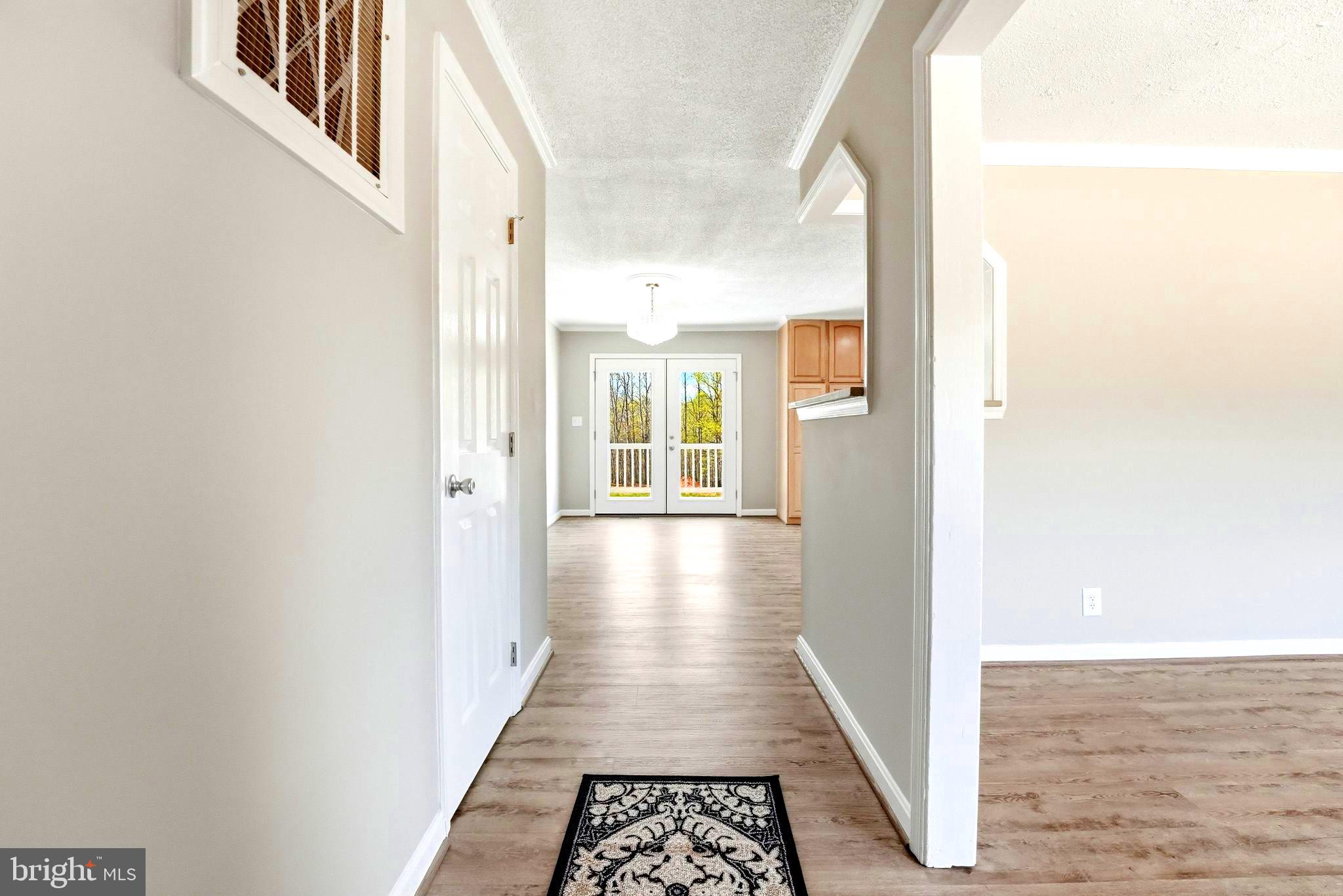 22064 Yellow Bottom Road Lignum, VA 22726 - Photo 14 of 50 a view of a hallway with wooden floor and staircase