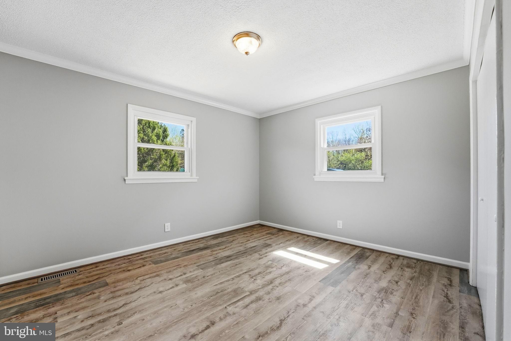 22064 Yellow Bottom Road Lignum, VA 22726 - Photo 24 of 50 a view of empty room with wooden floor and fan