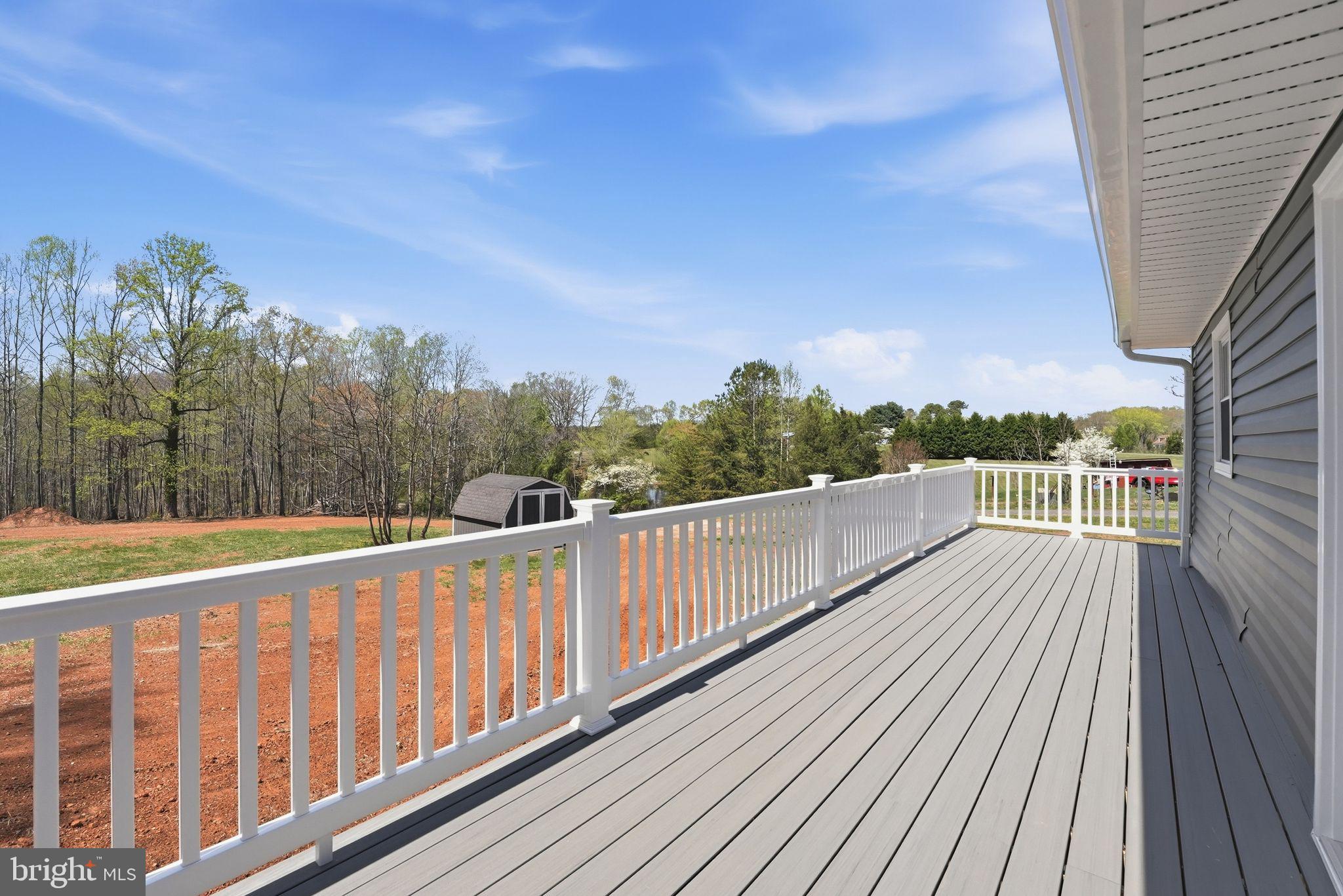 22064 Yellow Bottom Road Lignum, VA 22726 - Photo 33 of 50 a view of a balcony with wooden floor and fence
