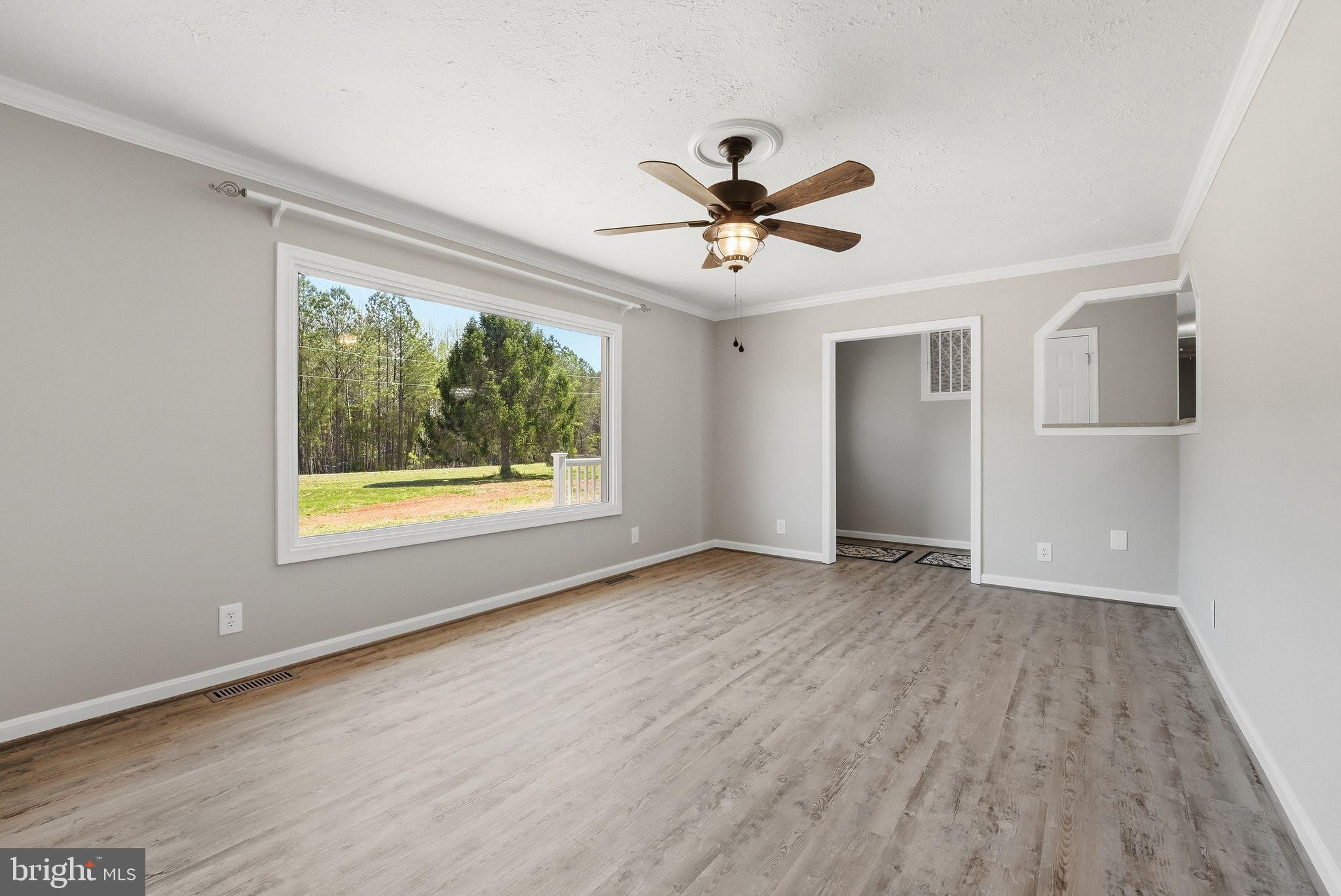 22064 Yellow Bottom Road Lignum, VA 22726 - Photo 10 of 50 a view of empty room with wooden floor and fan