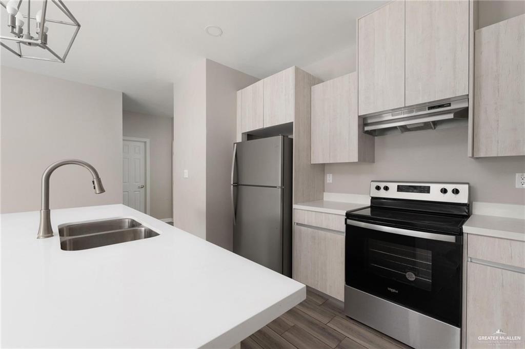 415 East 3rd Street La Joya, TX 78560 - Photo 4 of 11 a kitchen with stainless steel appliances a stove refrigerator and sink