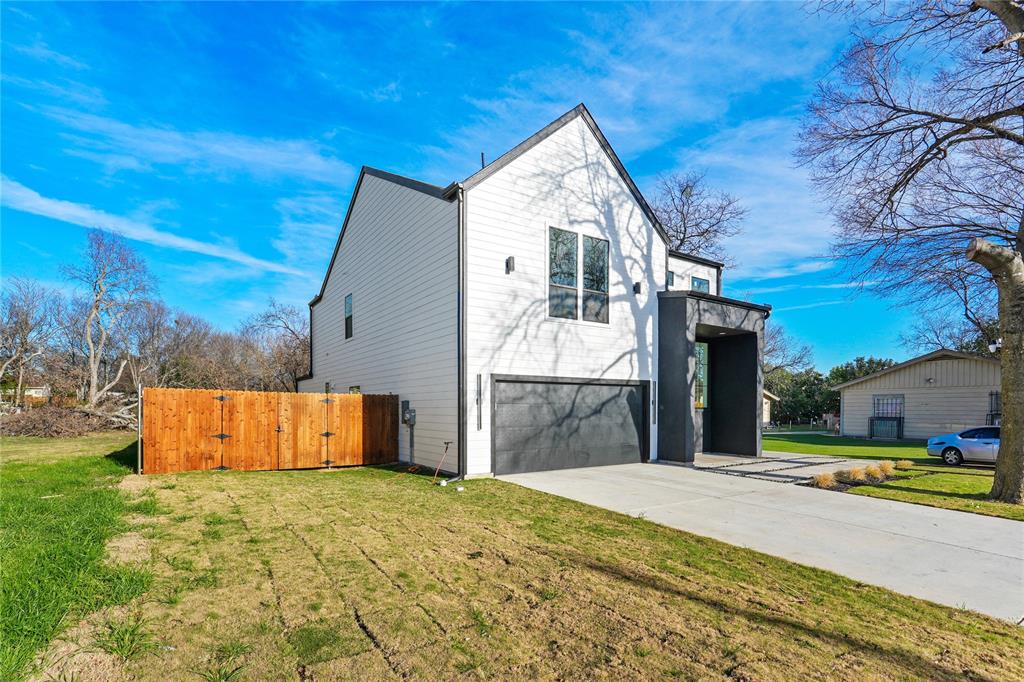 4712 Garrison Street Dallas, TX 75216 - Photo 3 of 30 View of side of property featuring concrete driveway, a garage, and a gate