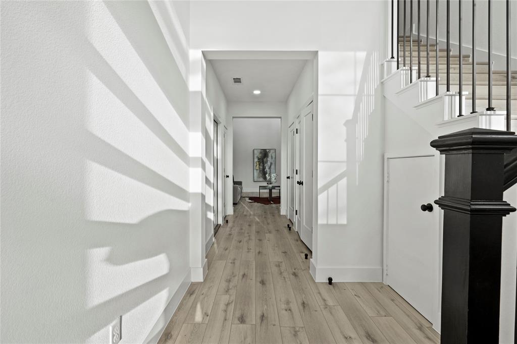 4712 Garrison Street Dallas, TX 75216 - Photo 5 of 30 Hallway with light wood-style floors and stairs