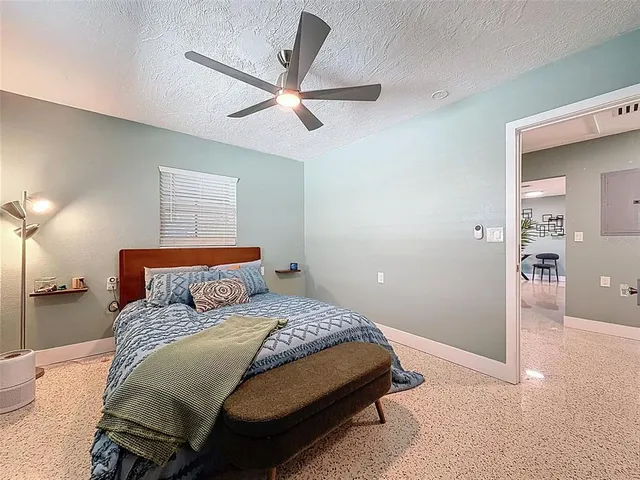 a bedroom with a bed and a chandelier