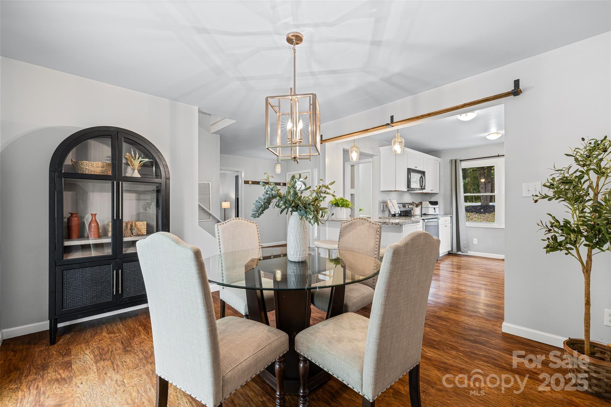 6027 Windjammer Drive Tega Cay, SC 29708 - Photo 11 of 34 a view of a dining room with furniture window and wooden floor