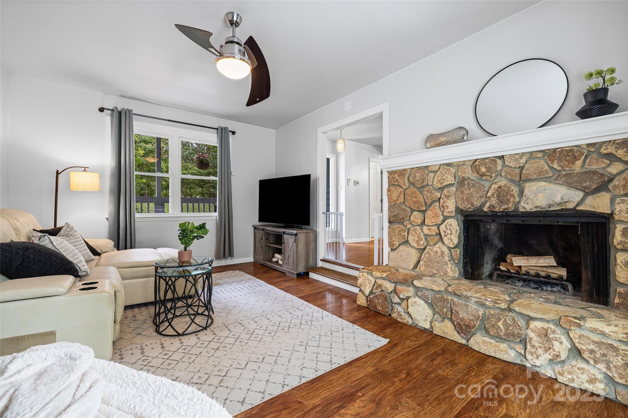 6027 Windjammer Drive Tega Cay, SC 29708 - Photo 14 of 34 a living room with furniture a fireplace and a flat screen tv