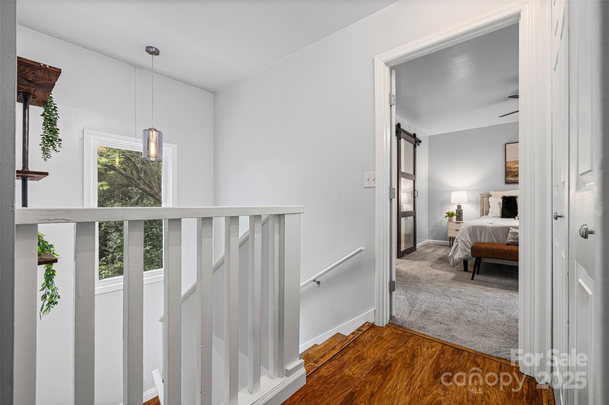 6027 Windjammer Drive Tega Cay, SC 29708 - Photo 18 of 34 a view of a bedroom from a hallway