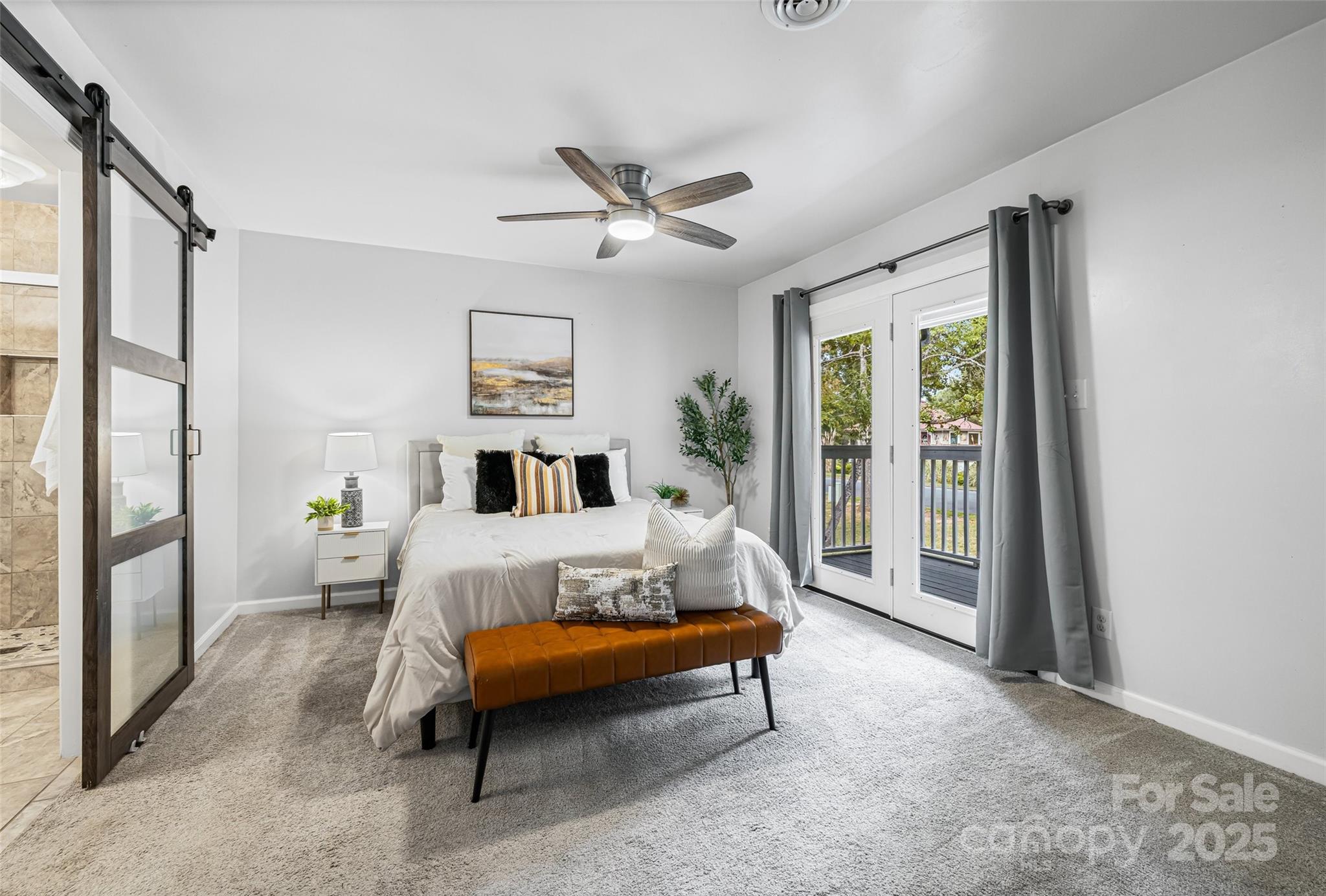 6027 Windjammer Drive Tega Cay, SC 29708 - Photo 19 of 34 a bedroom with furniture and a large window