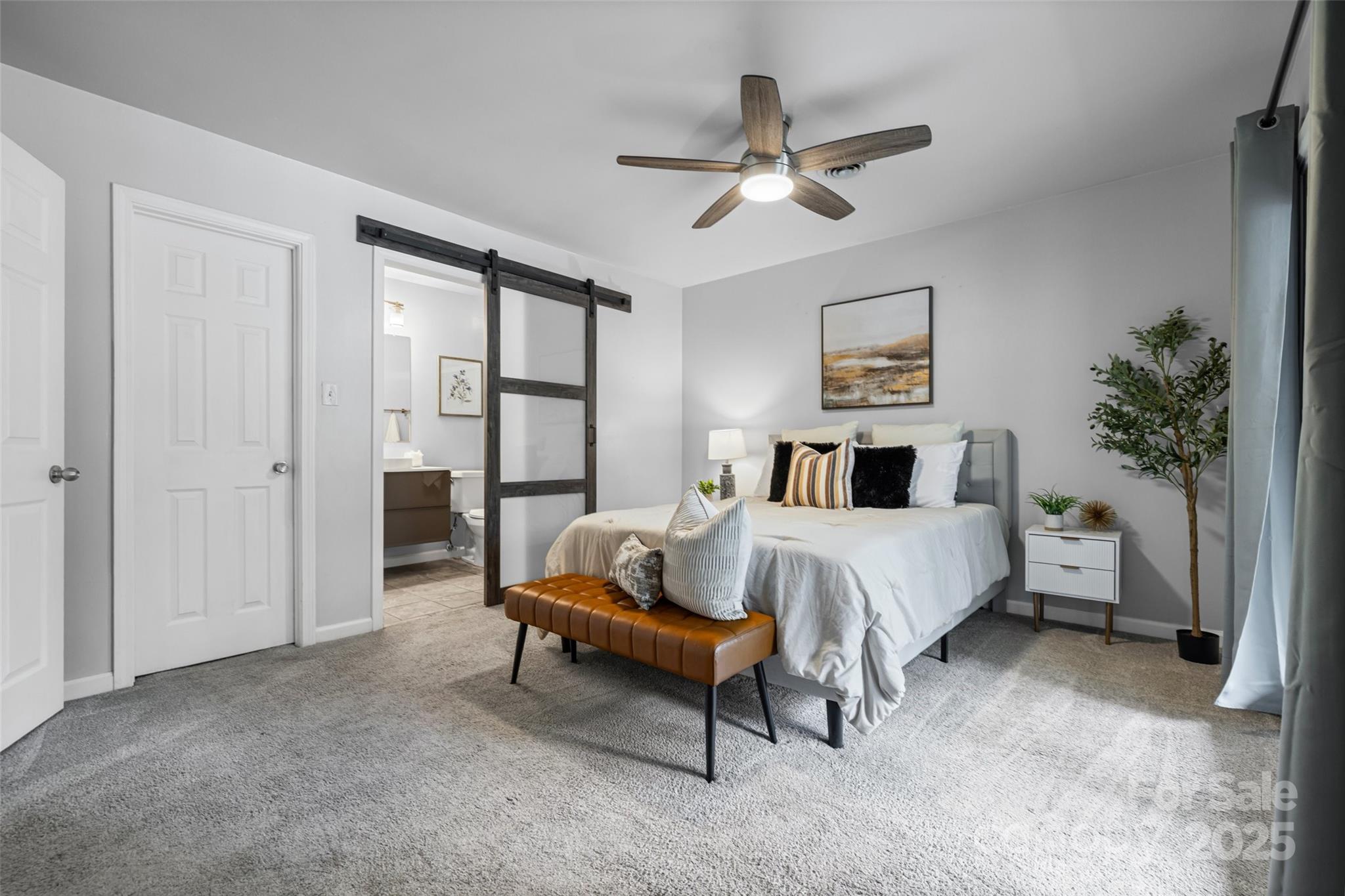 6027 Windjammer Drive Tega Cay, SC 29708 - Photo 20 of 34 a bedroom with a bed and a chandelier