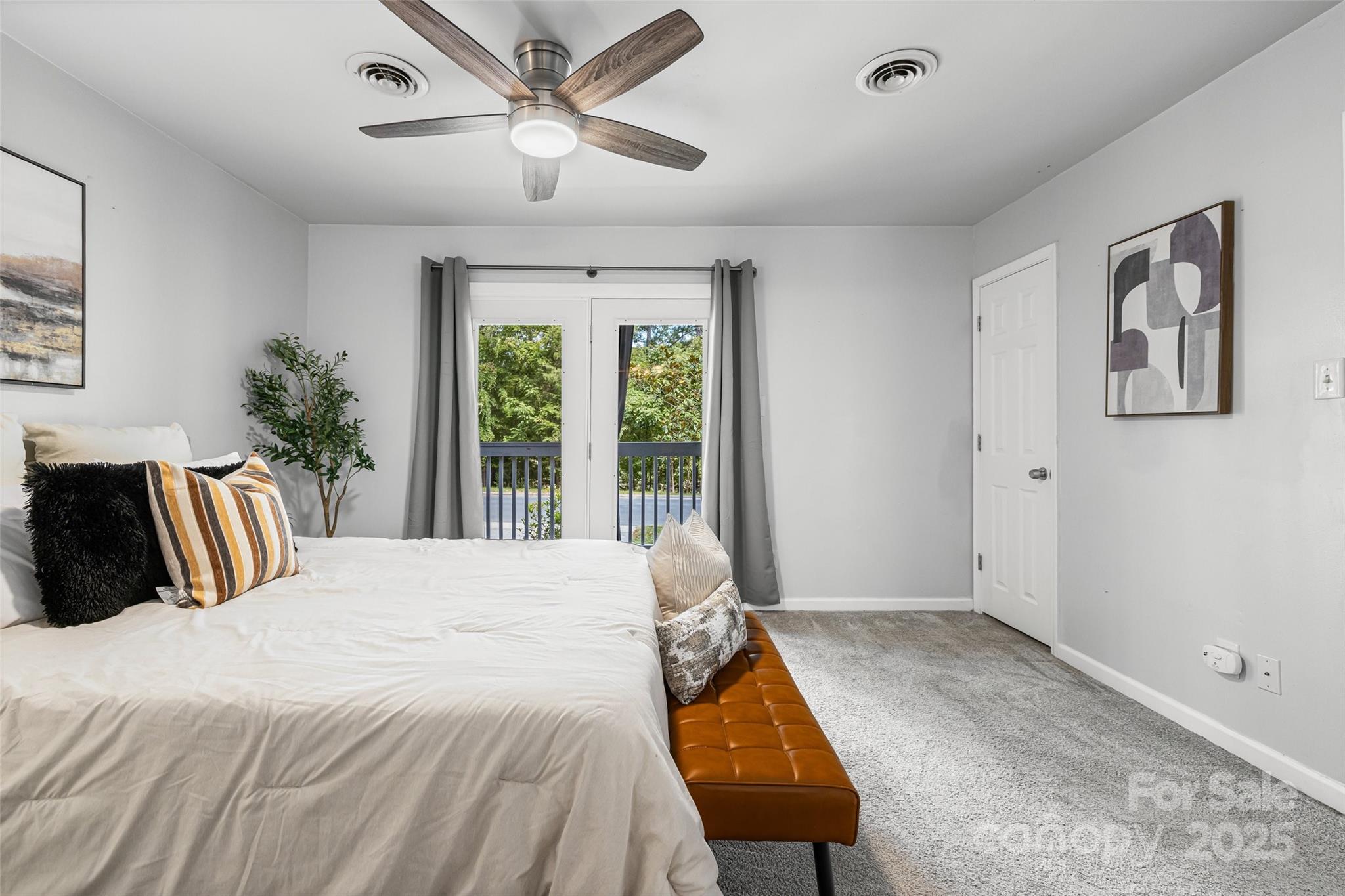 6027 Windjammer Drive Tega Cay, SC 29708 - Photo 21 of 34 a bedroom with a large bed and a large window