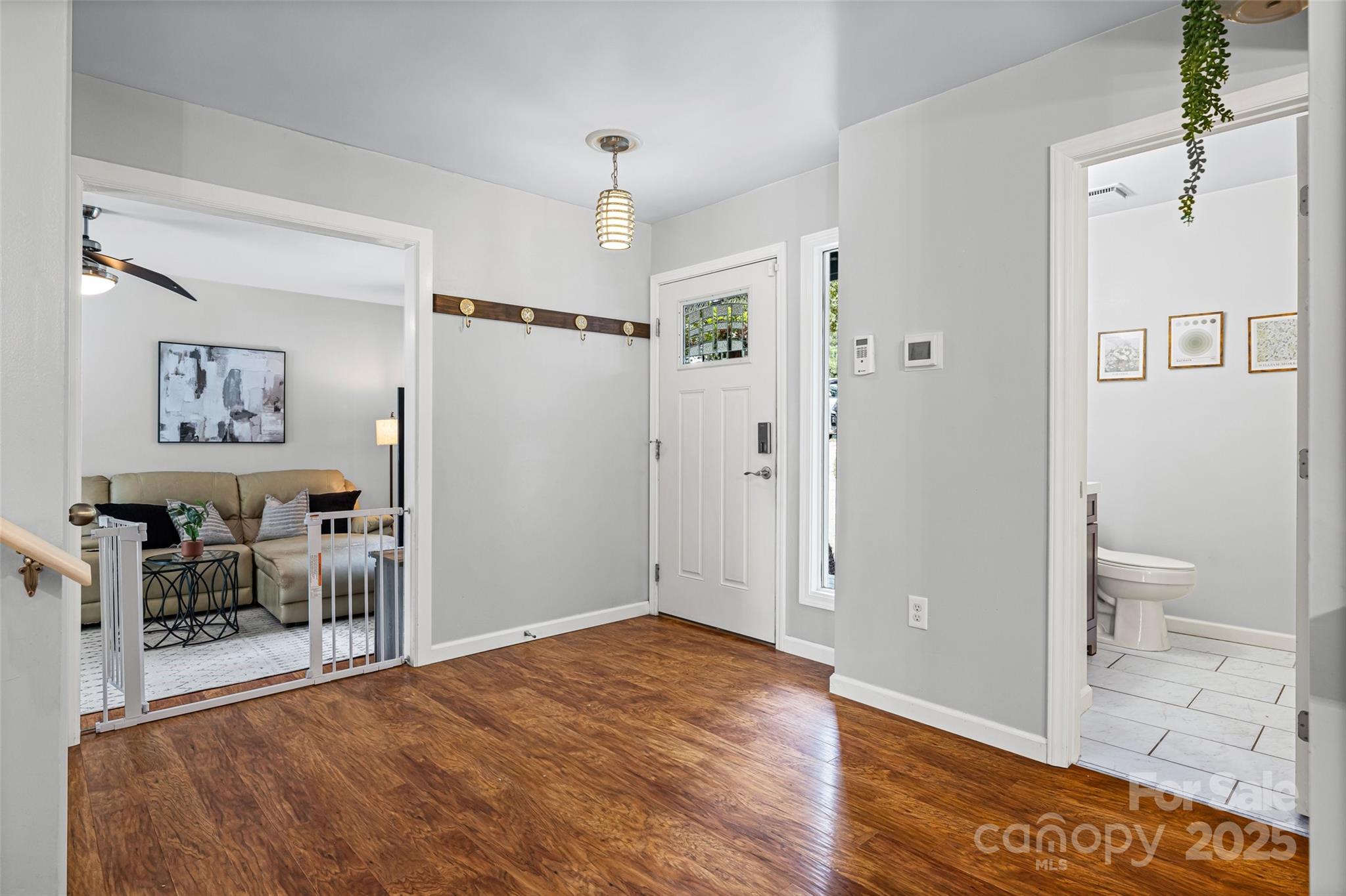 6027 Windjammer Drive Tega Cay, SC 29708 - Photo 3 of 34 a view of a room with wooden floor and furniture