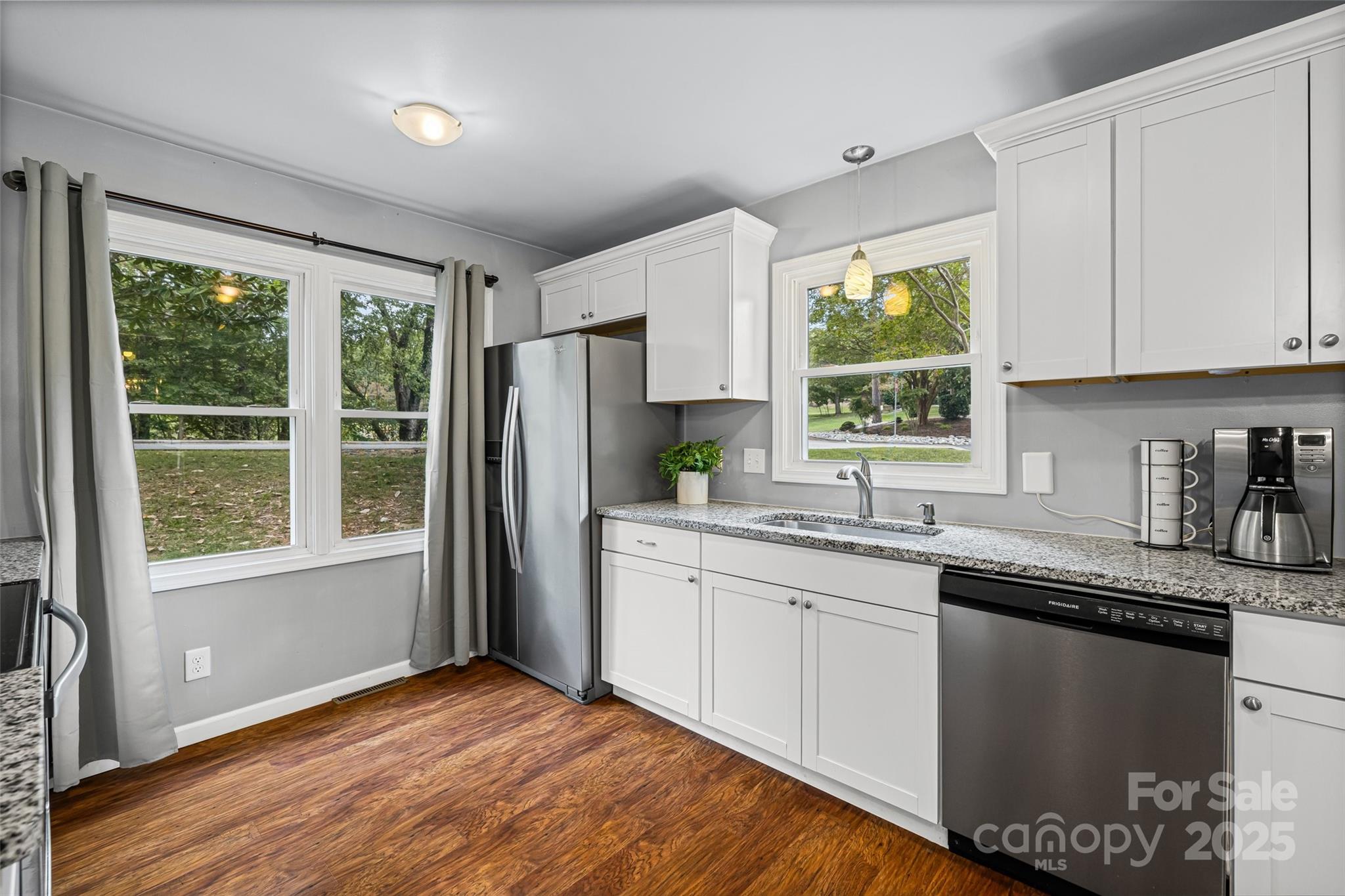 6027 Windjammer Drive Tega Cay, SC 29708 - Photo 5 of 34 a kitchen with granite countertop stainless steel appliances a sink window and cabinets