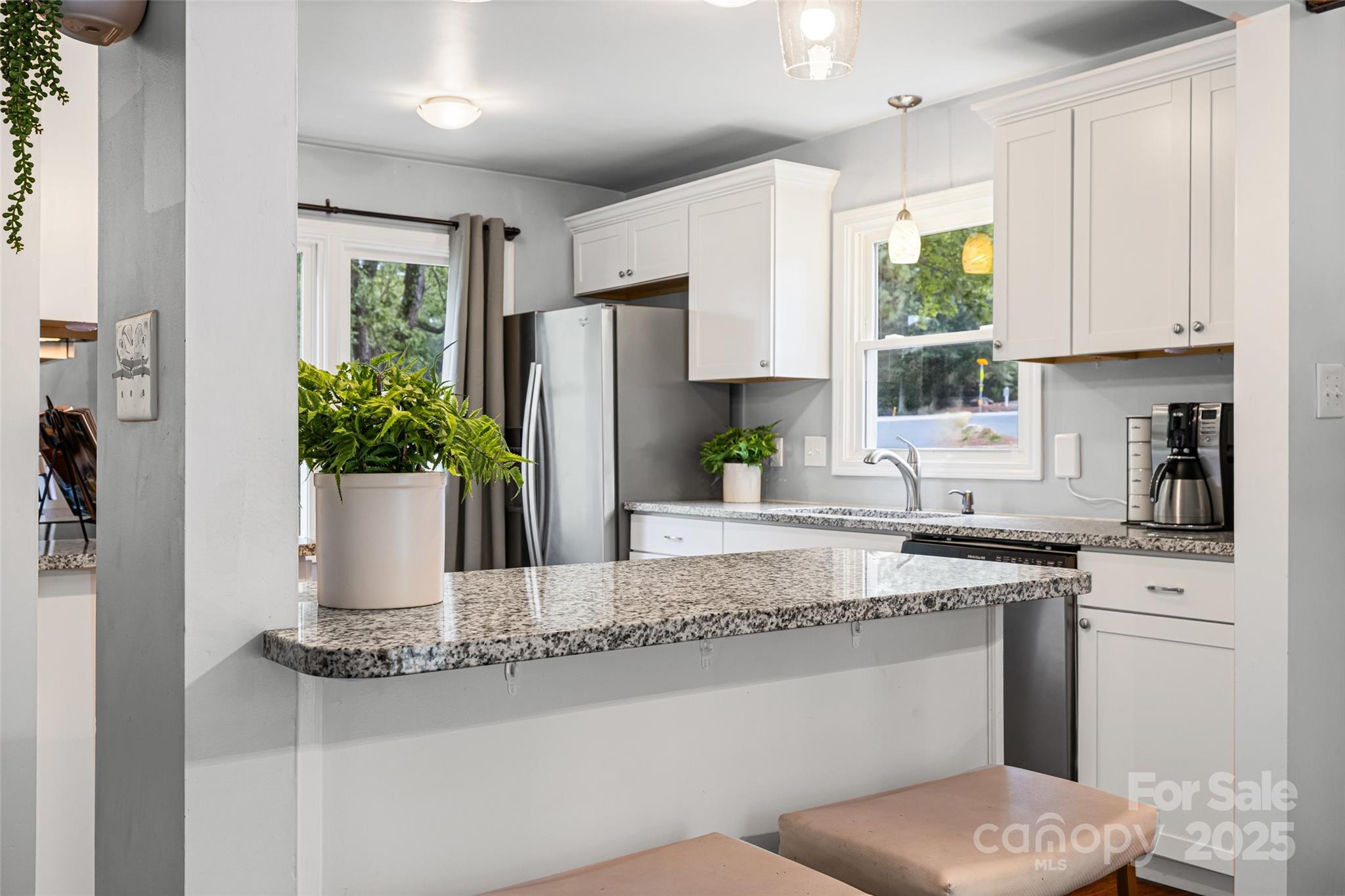6027 Windjammer Drive Tega Cay, SC 29708 - Photo 9 of 34 a kitchen with stainless steel appliances granite countertop a refrigerator and a sink