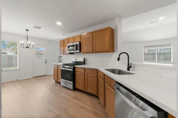 a kitchen with a sink cabinets and appliances