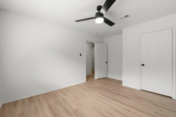 a view of an empty room and wooden floor