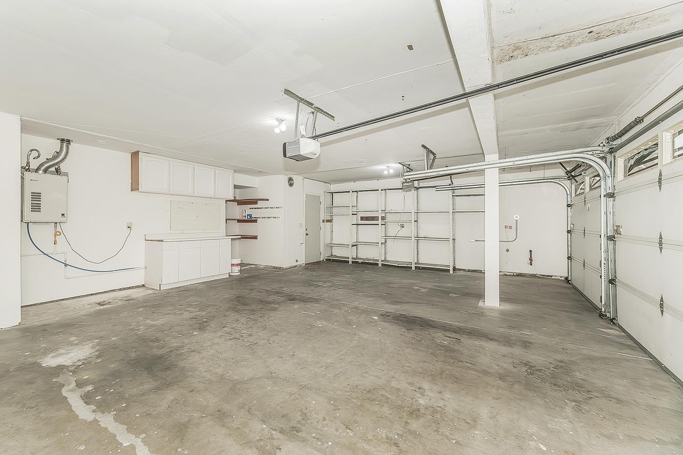 837 East Buckhill Road Fresno, CA 93720 - Photo 45 of 55 3-car garage with storage cabinets and shelving