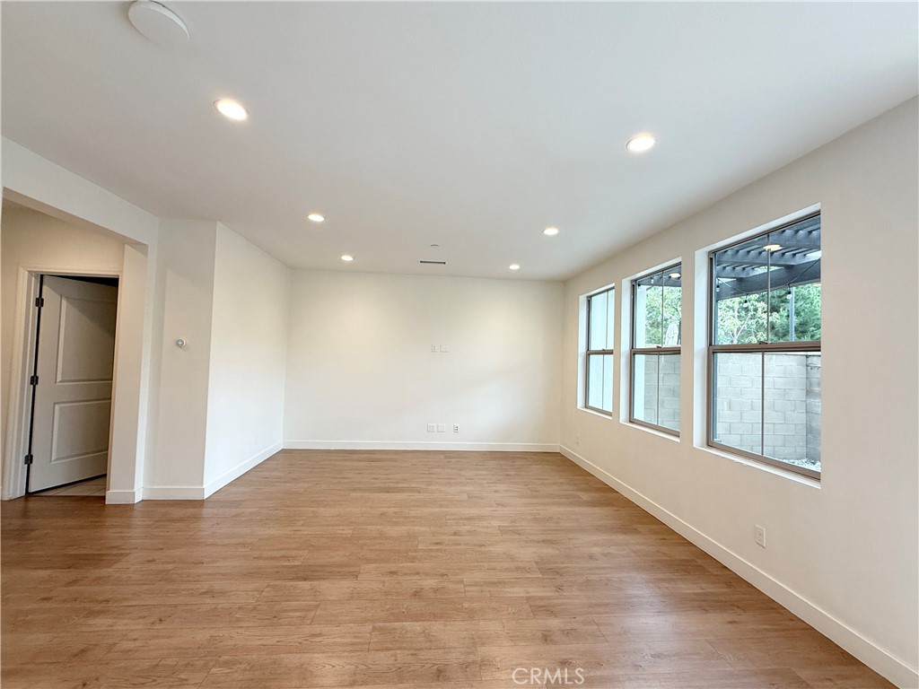 126 Okra Irvine, CA 92618 - Photo 4 of 26 a view of empty room with wooden floor and fan