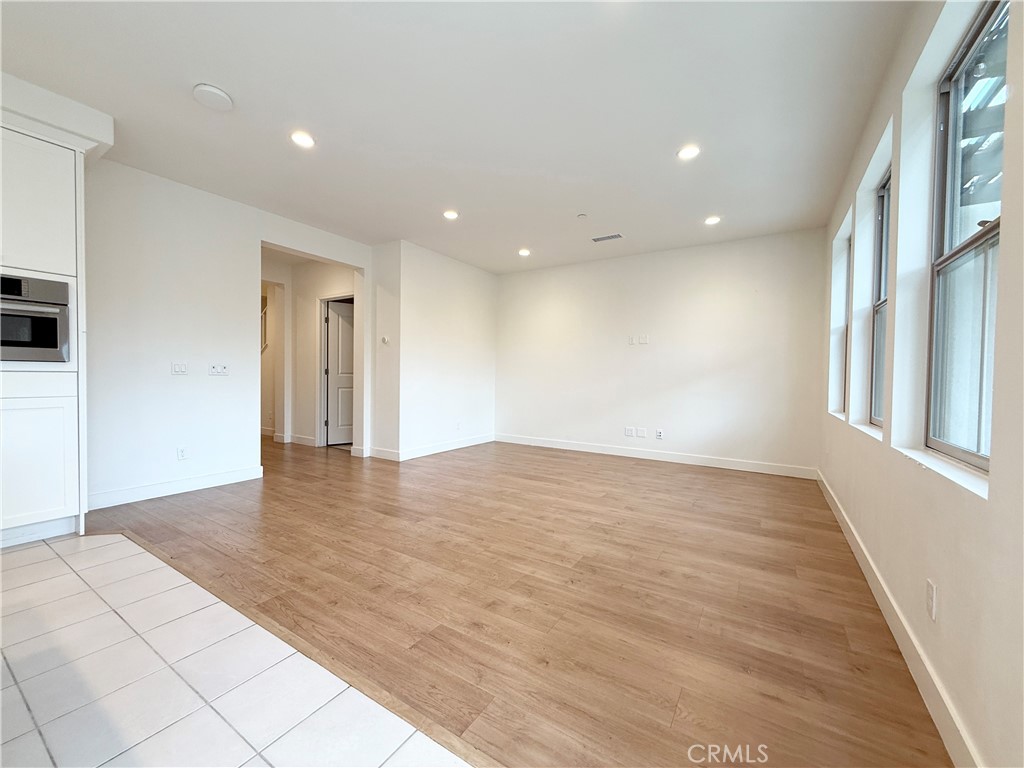 126 Okra Irvine, CA 92618 - Photo 5 of 26 a view of an empty room with wooden floor and a window