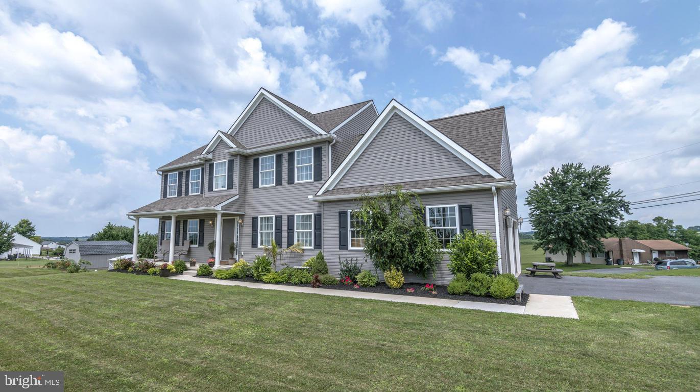 1033 Spring Valley Road Quarryville, PA 17566 - Photo 3 of 33 a front view of a house with a yard