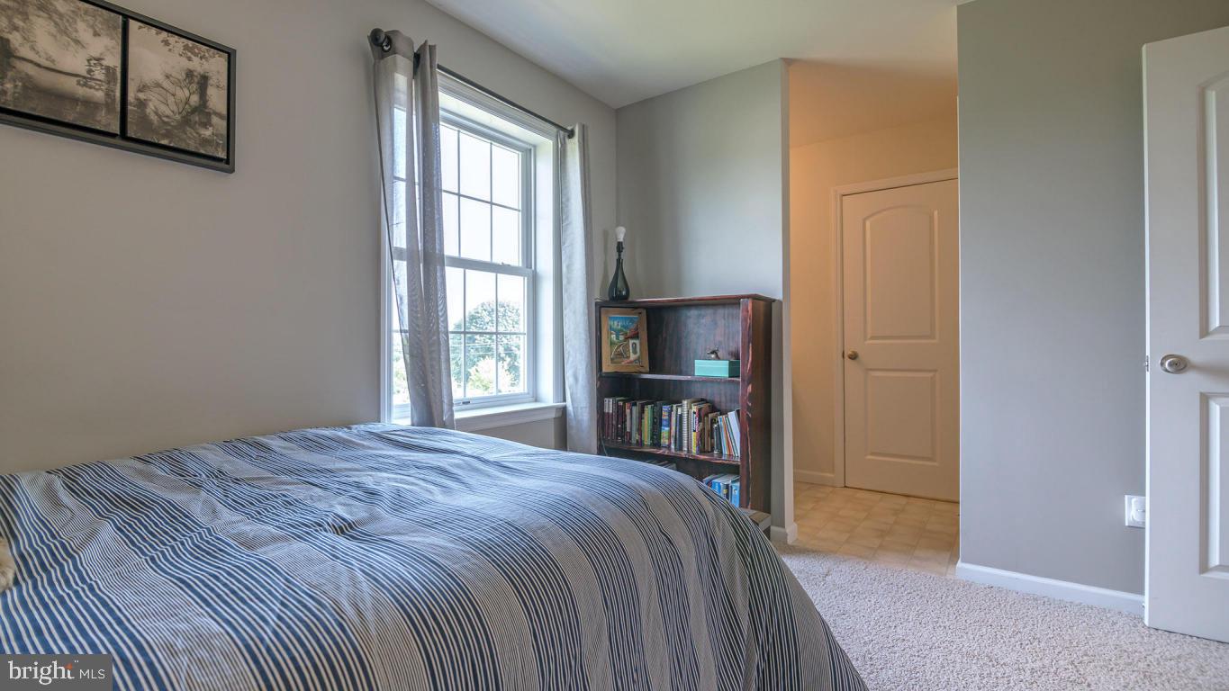 1033 Spring Valley Road Quarryville, PA 17566 - Photo 22 of 33 a bedroom with a bed and a flat tv screen