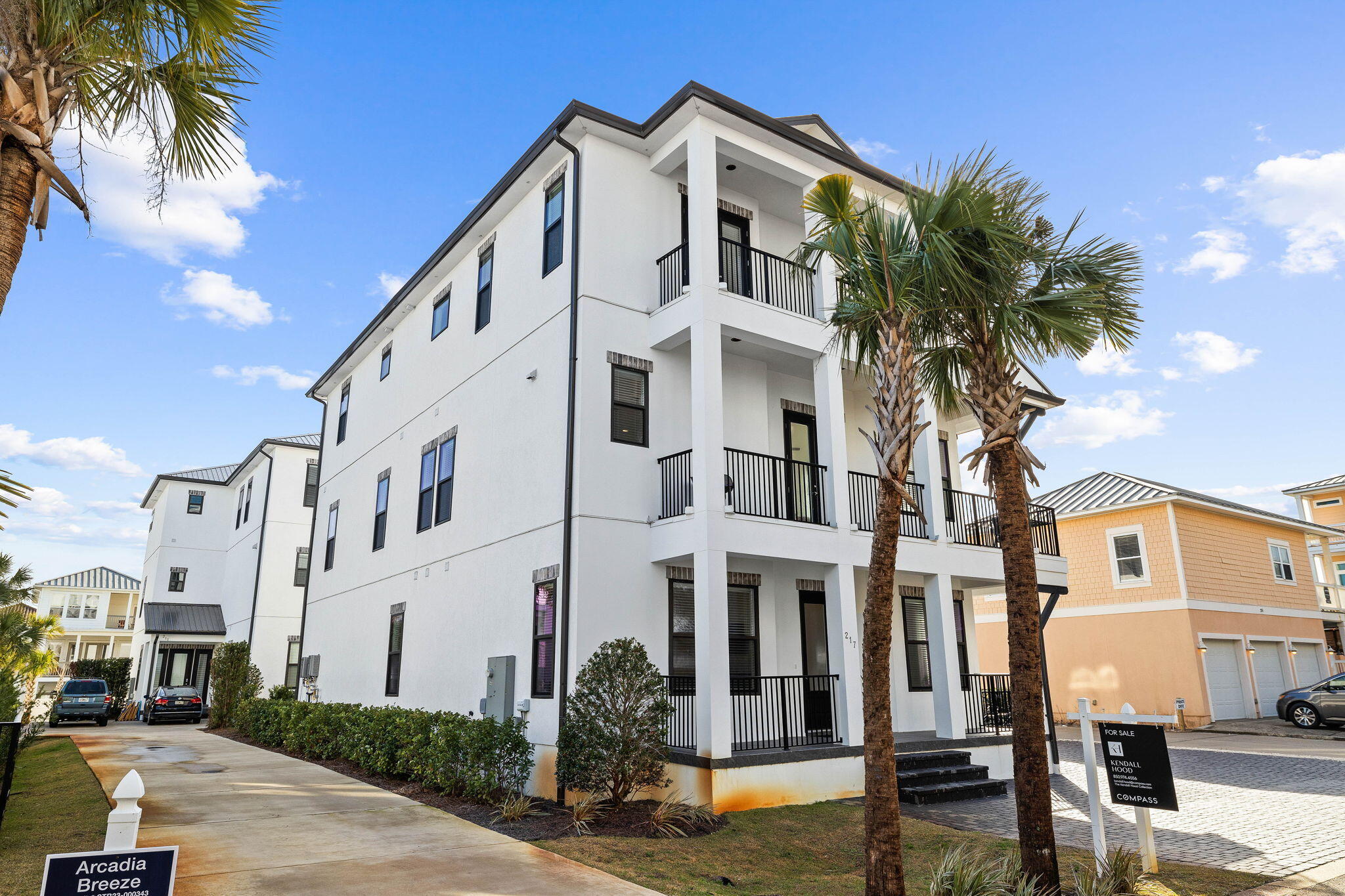 217 Snowdrift Road Miramar Beach, FL 32550 - Photo 104 of 106 a view of a white building among the street with palm trees