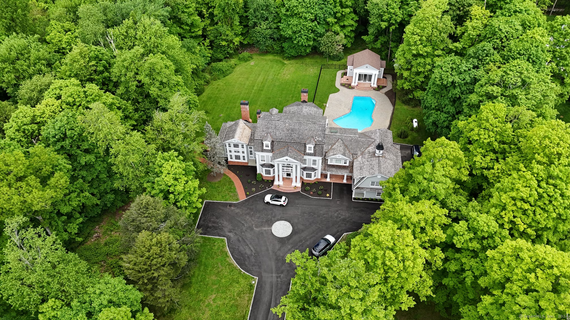 aerial view of a house with a yard and outdoor seating