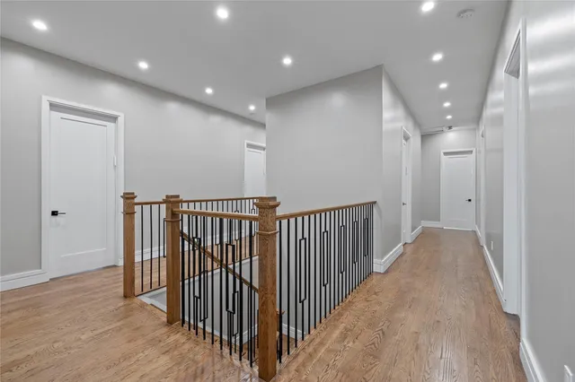 a view of a hallway with wooden floor