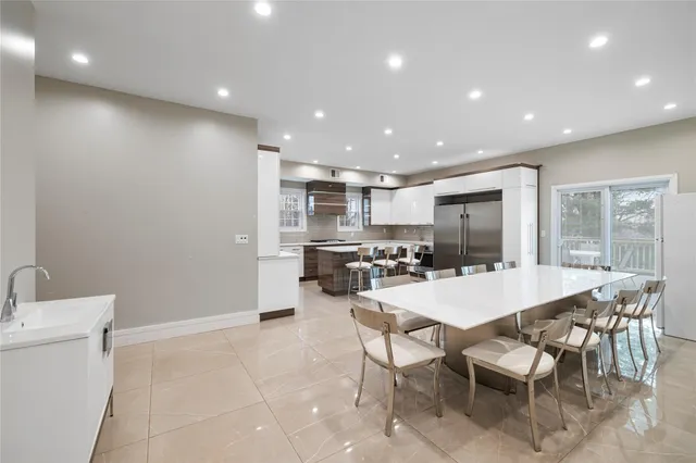 a large kitchen with a table and chairs