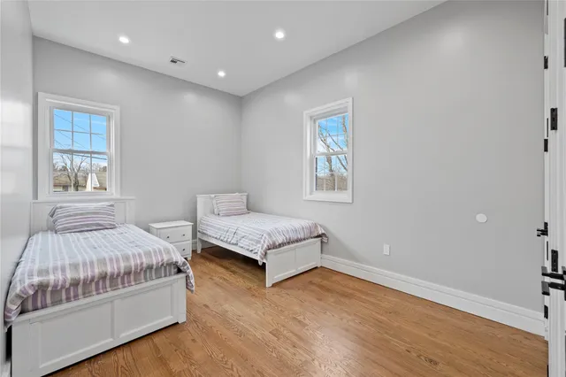 a spacious bedroom with a bed and window