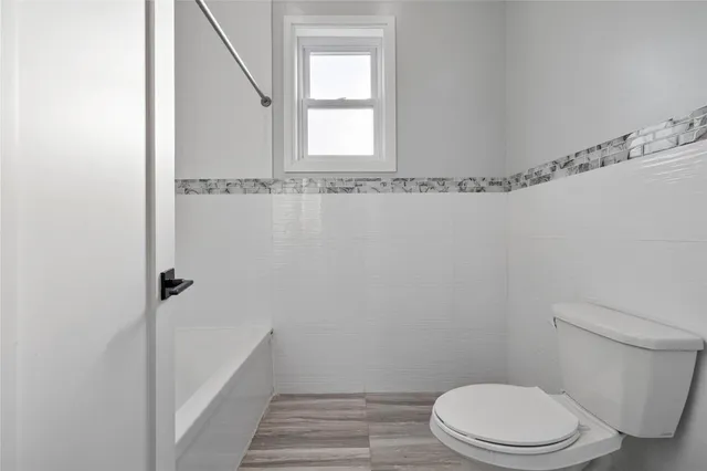 a view of bathroom with a tub sink and mirror