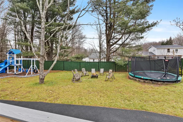 a view of a swimming pool with a bench and trees