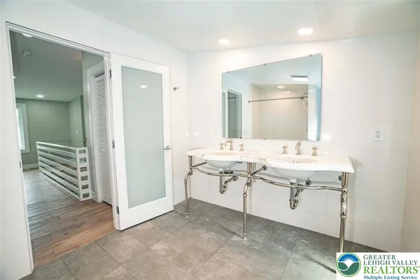 a bathroom with a sink a mirror and a shower