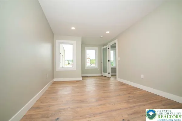 a room with windows and wooden floor