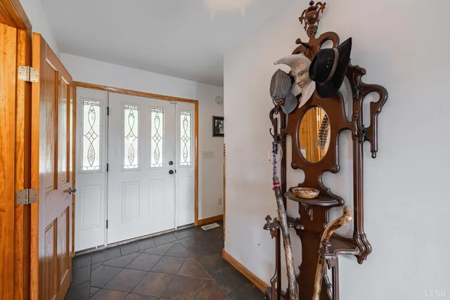 a kitchen with stainless steel appliances granite countertop a refrigerator a stove a sink a dining table and chairs with wooden floor