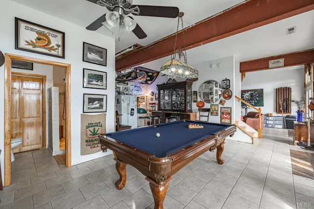 a view of a balcony with chairs and wooden floor