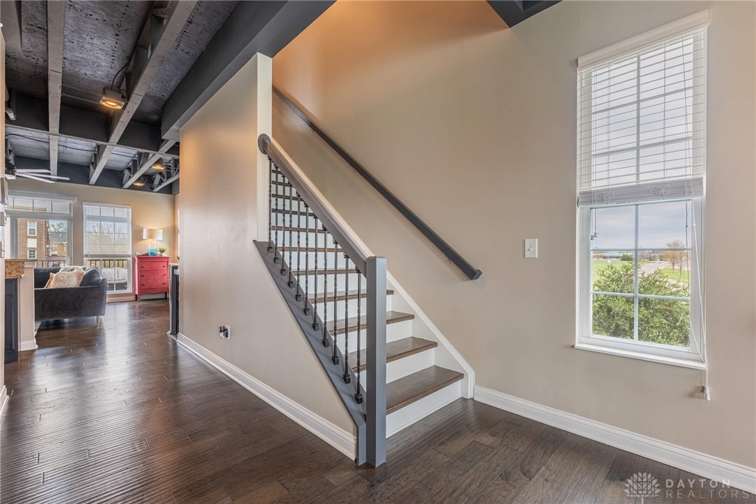 407 Brownstone Row Springboro, OH 45066 - Photo 23 of 54 This interior hallway features beautiful hardwood flooring and a stylish staircase.