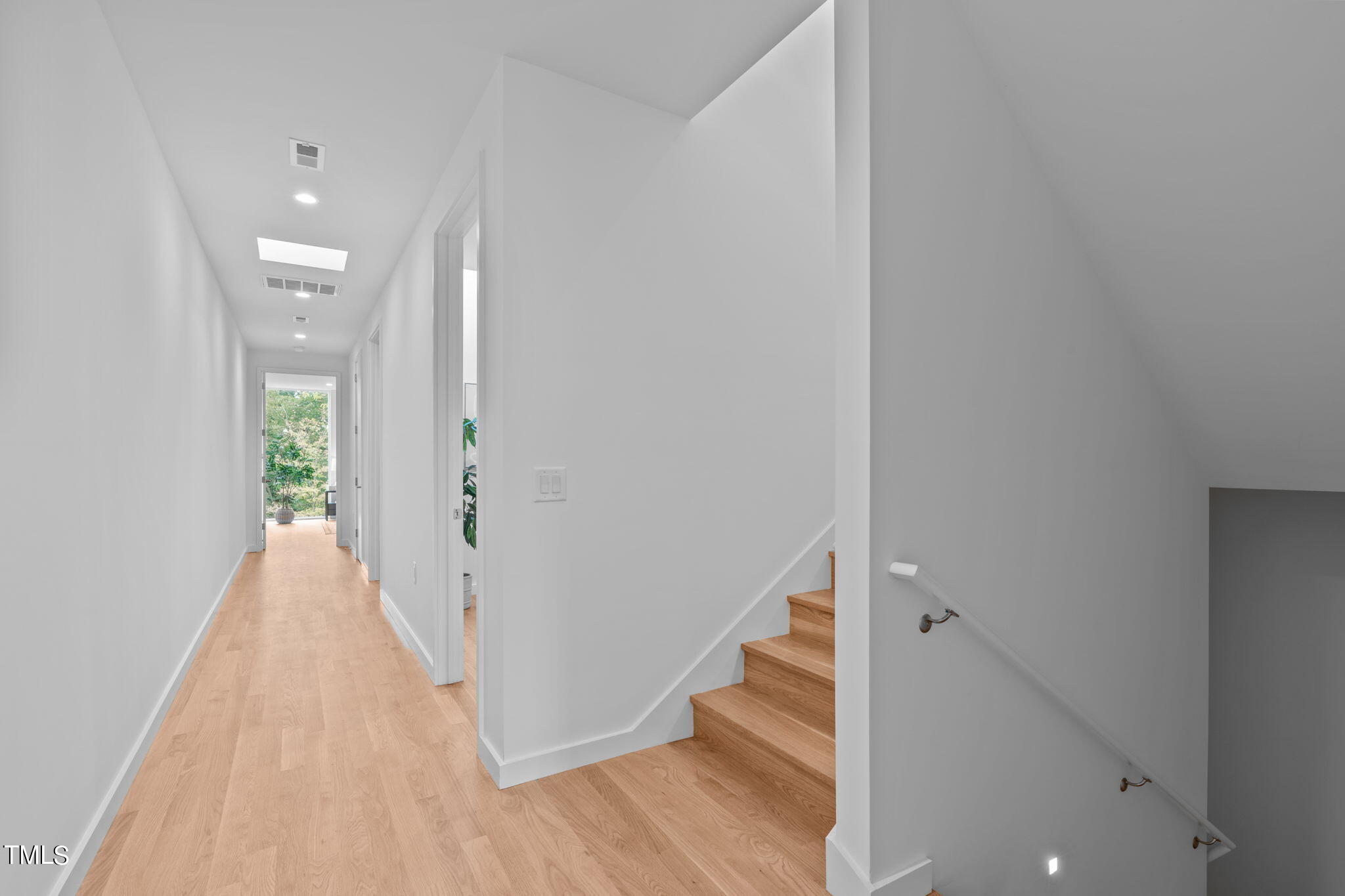 511 South Bloodworth Street, Unit 102 Raleigh, NC 27601 - Photo 20 of 54 a view of a hallway with wooden floor and staircase