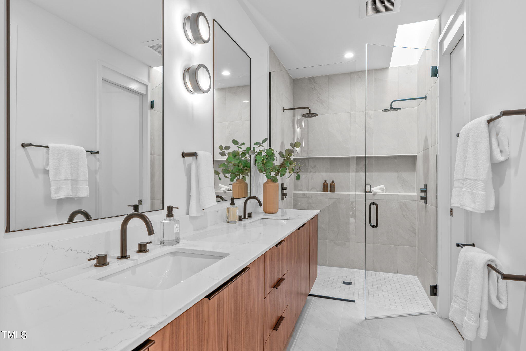 511 South Bloodworth Street, Unit 102 Raleigh, NC 27601 - Photo 25 of 54 a bathroom with a double vanity sink mirror and shower