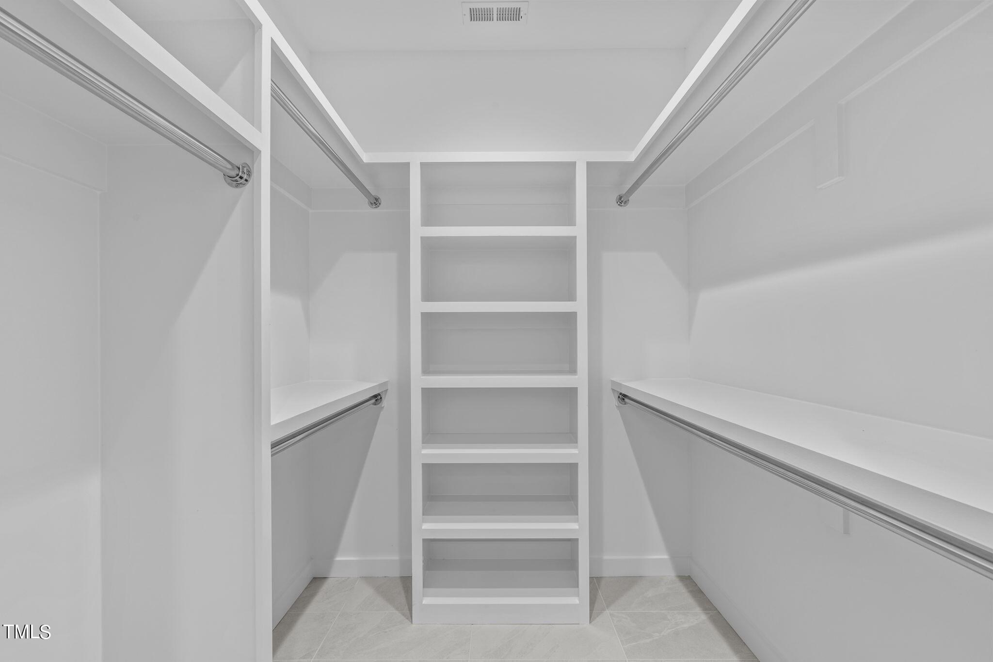 511 South Bloodworth Street, Unit 102 Raleigh, NC 27601 - Photo 26 of 54 a view of walk in closet with empty racks